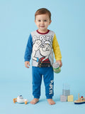 Child wearing Popeye-themed pajamas on a blue background