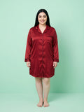 Woman wearing a red satin nightshirt against a light green background